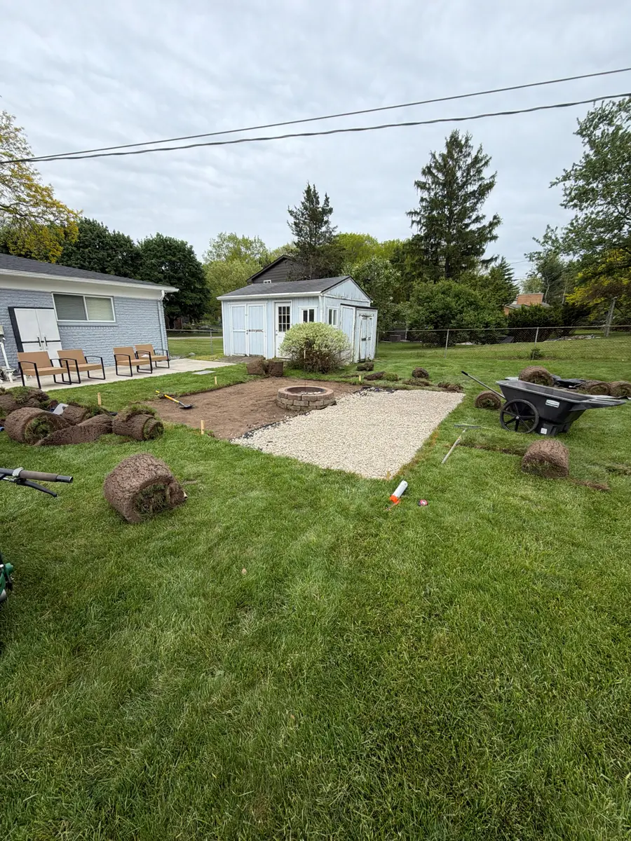 During — Backyard firepit and pea-gravel patio with stepping-stone path