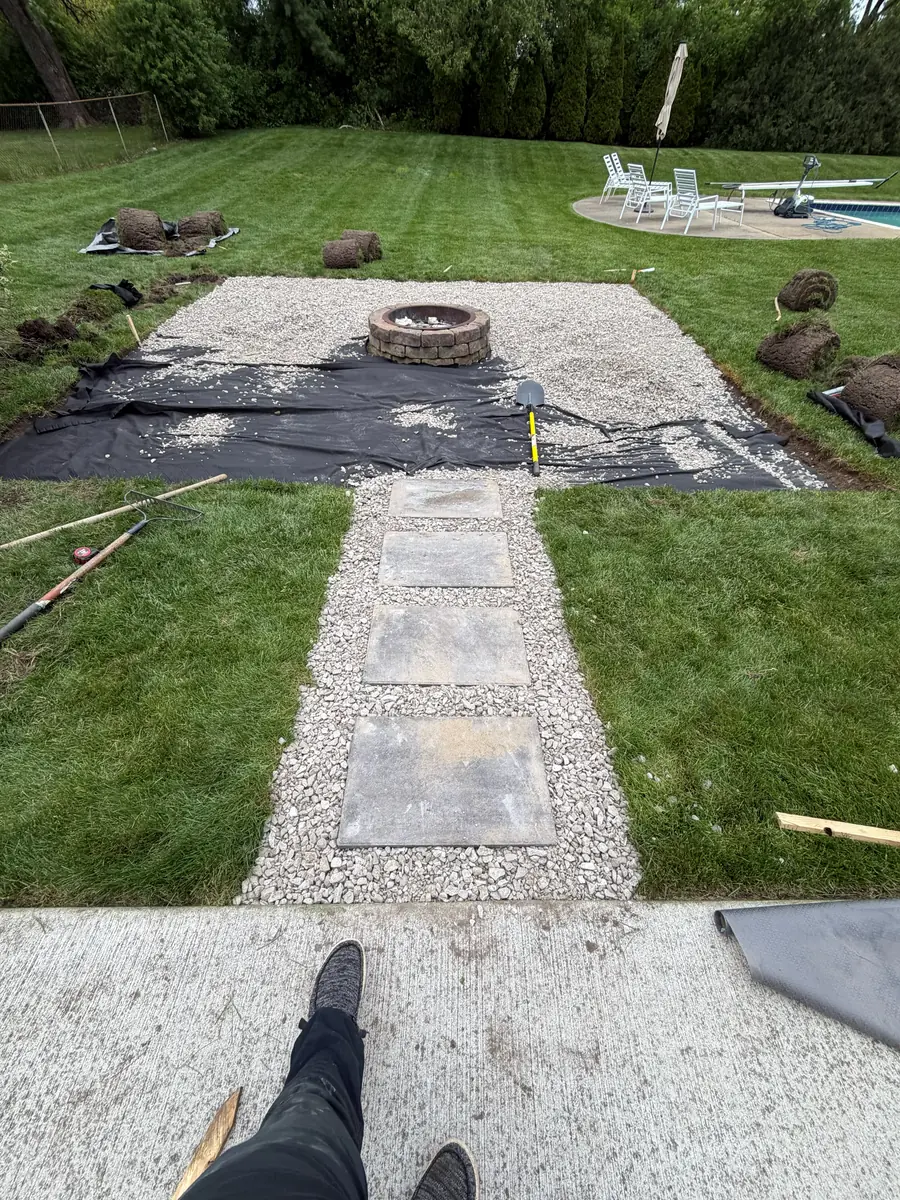 During — Backyard firepit and pea-gravel patio with stepping-stone path