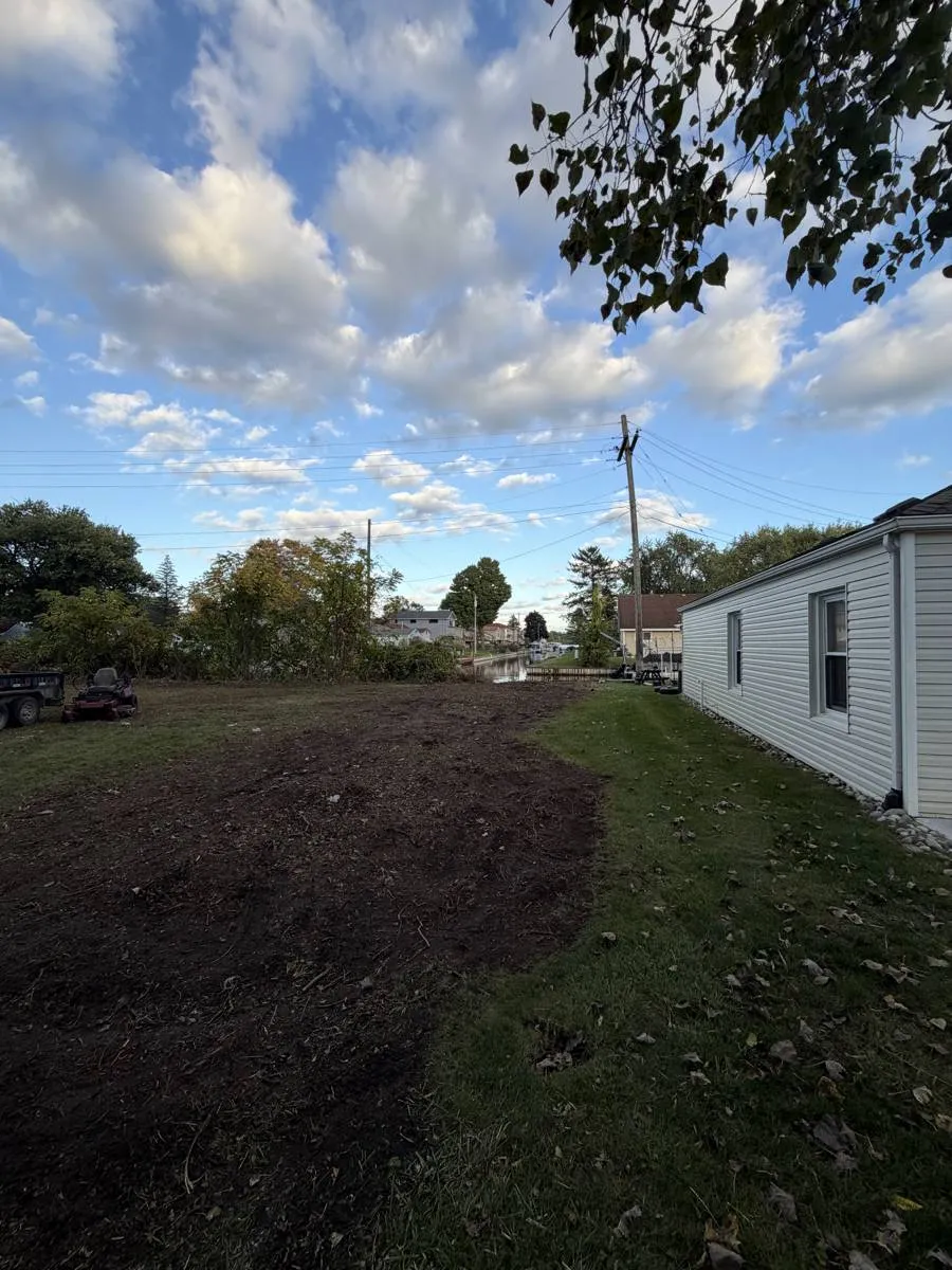 After — Overgrown lot line cleared down to the water