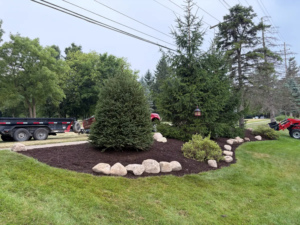 After — Flower bed rebuilt with boulder edging
