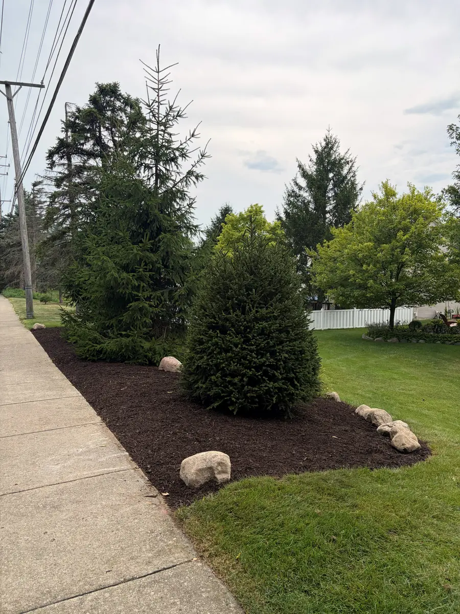 After — Flower bed rebuilt with boulder edging